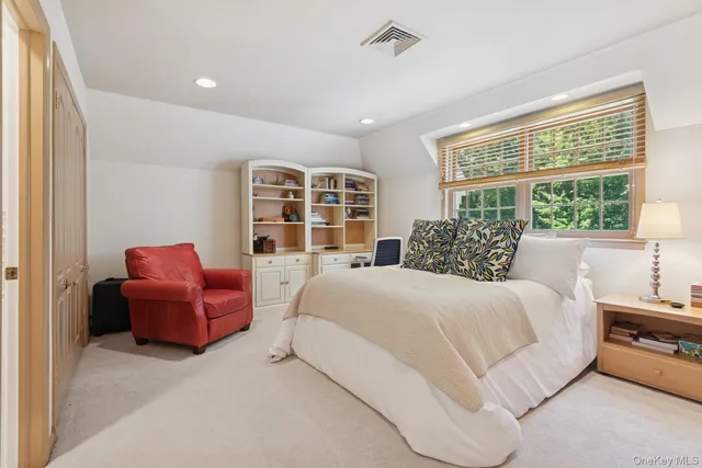 a bathroom with a granite countertop sink a toilet and a mirror