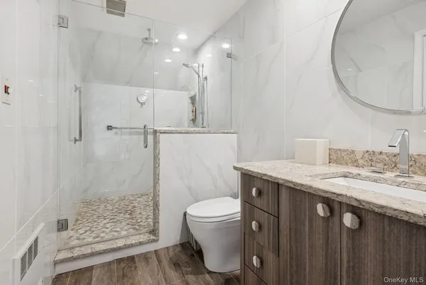 a spacious bedroom with a bed a dresser and a window