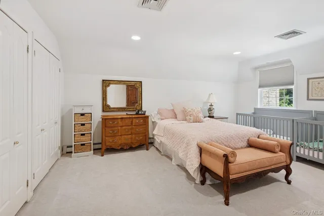 a spacious bedroom with a bed and a large window