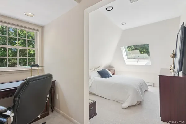 a bathroom with a granite countertop toilet sink and mirror
