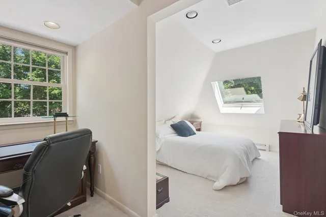 a bathroom with a granite countertop toilet sink and mirror