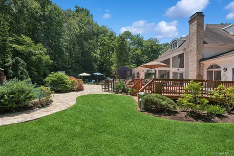 a view of a house with a yard and sitting area
