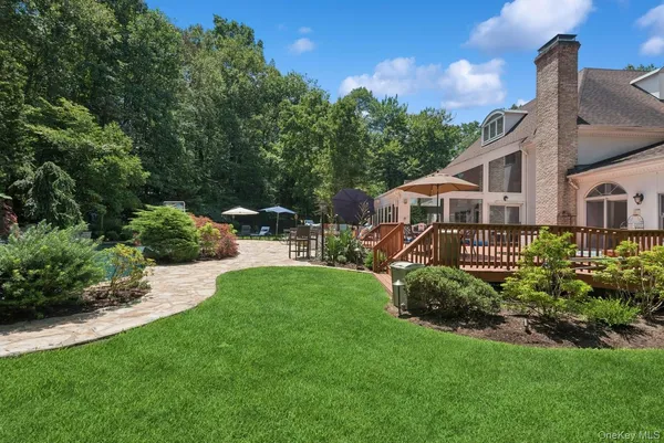 a view of a house with a yard and sitting area