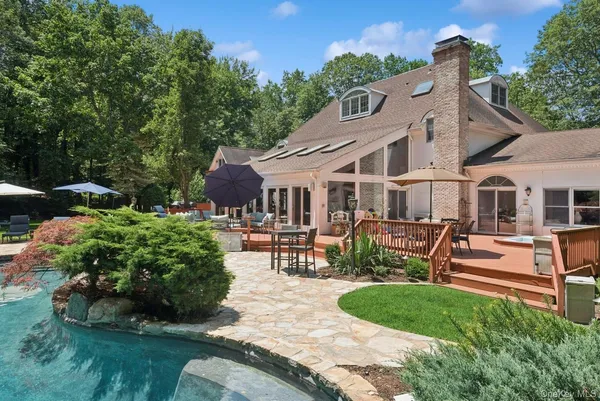 a patio with wooden table and chairs