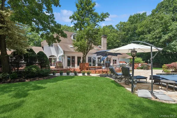 a view of a house with backyard and sitting area