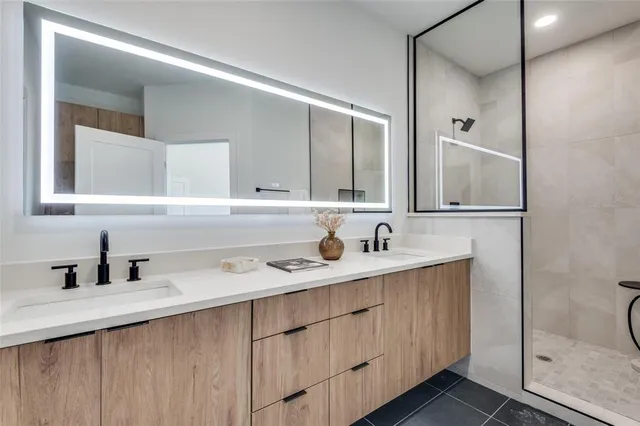 a view of a kitchen with a sink and dishwasher a refrigerator with wooden floor