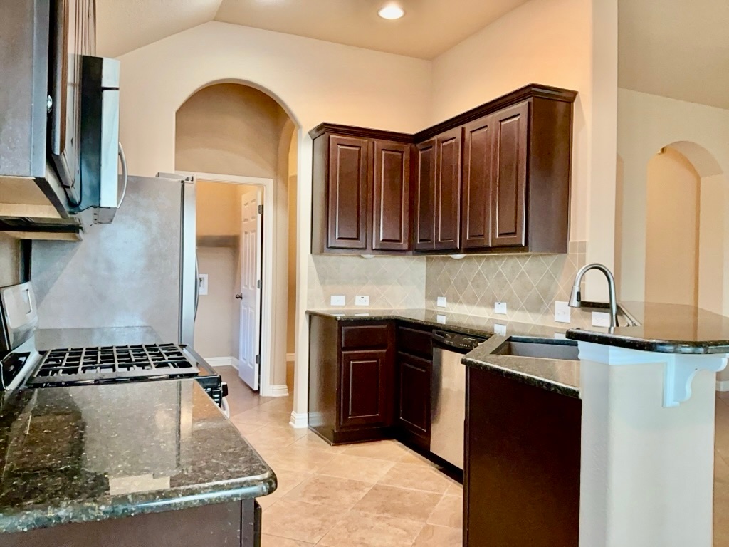 3580 Rosalina Loop Round Rock, TX 78665 - Photo 13 of 27 a kitchen with sink a stove and cabinets