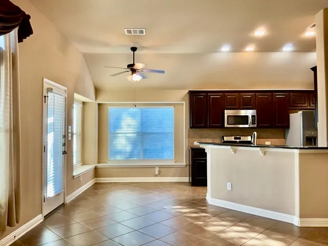 a view of a kitchen with a sink and a refrigerator