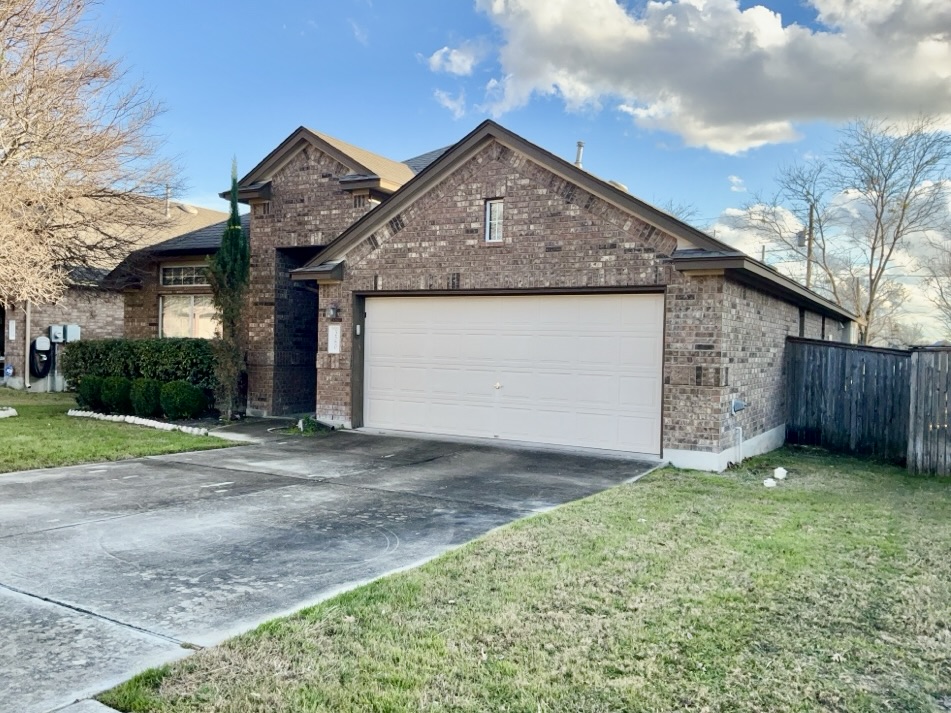 3580 Rosalina Loop Round Rock, TX 78665 - Photo 2 of 27 a front view of a house with a garden and yard