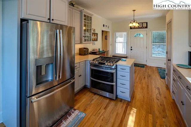 a kitchen with stainless steel appliances granite countertop a refrigerator stove and sink
