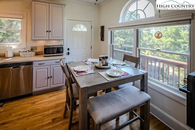 a kitchen with a table chairs stove and cabinets