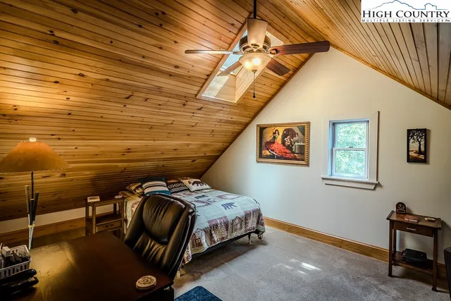 a bedroom with bed and a chandelier