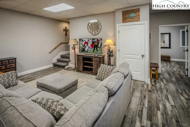 a living room with furniture and a wooden floor