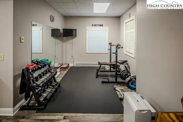 a room with gym equipment and a flat screen tv