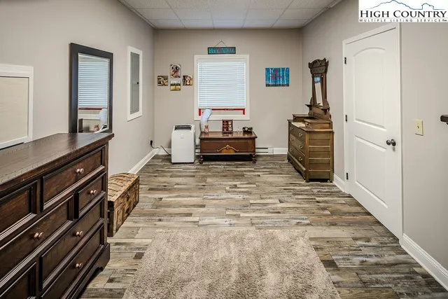 a living room with stainless steel appliances furniture a refrigerator and a stove