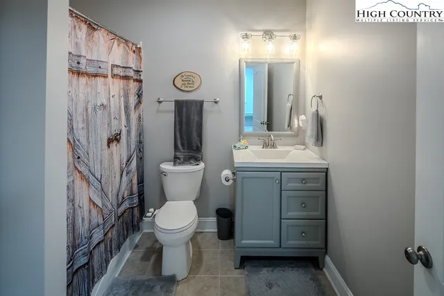 a bathroom with a toilet sink and a mirror