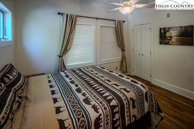 a bed sitting in a bedroom next to a window