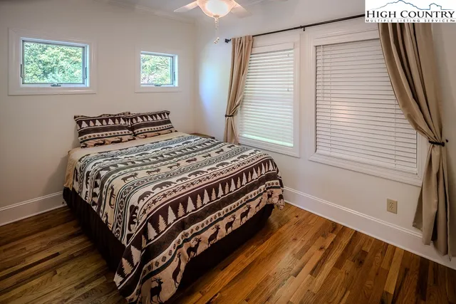 a bedroom with a bed next to a window