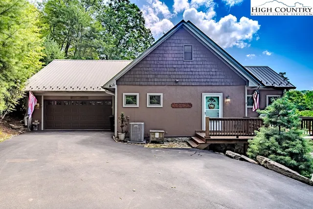 a view of a house with a yard and sitting area