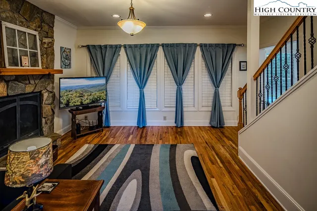 a view of a living room and entryway with wooden floor