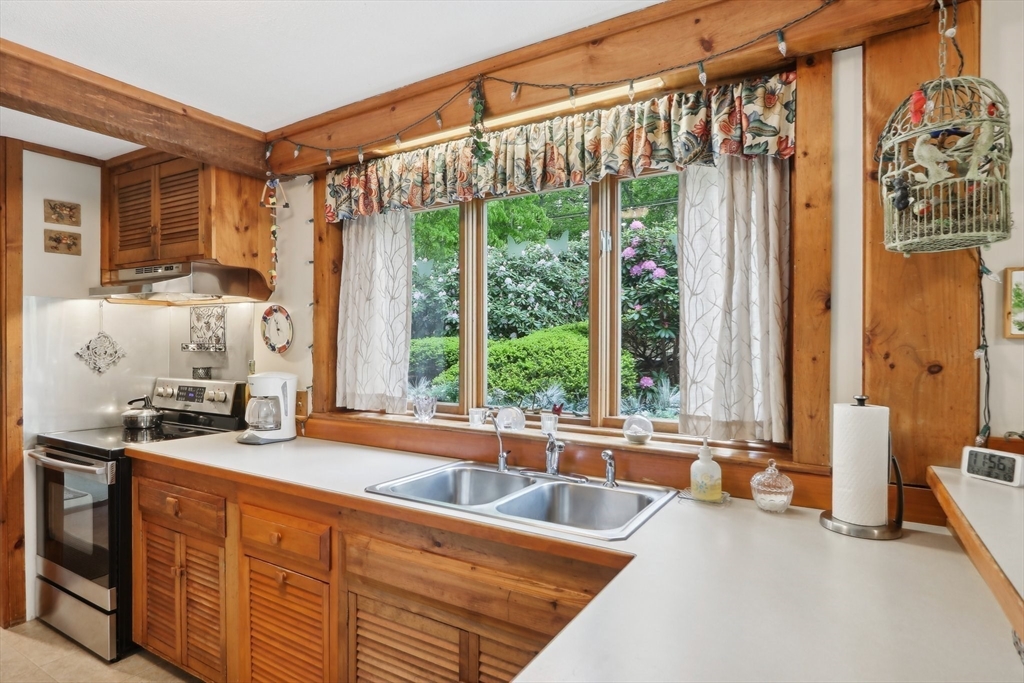 56 Pine Point Road Stow, MA 01775 - Photo 12 of 34 a spacious bathroom with a granite countertop sink and a large mirror