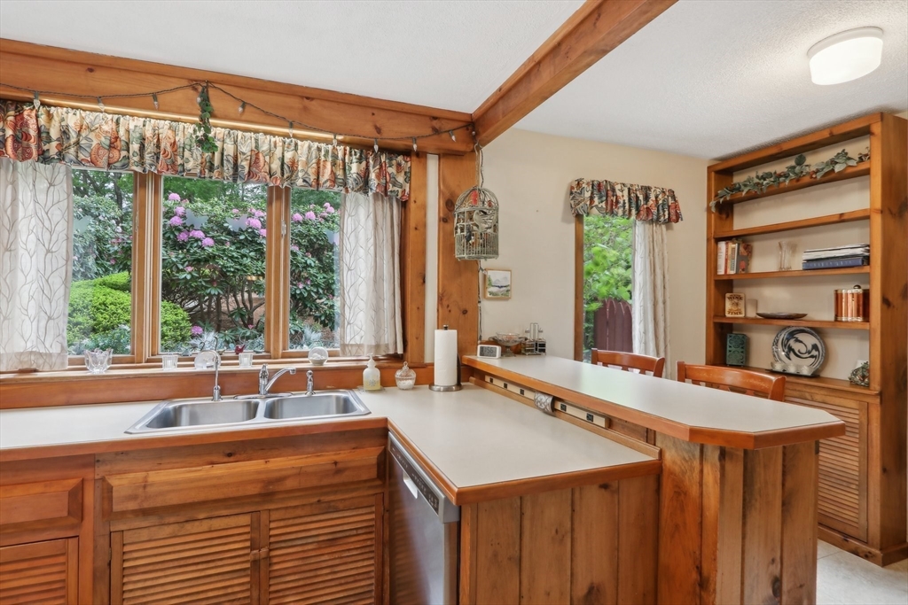 56 Pine Point Road Stow, MA 01775 - Photo 13 of 34 a view of a kitchen with a large window and a counter space