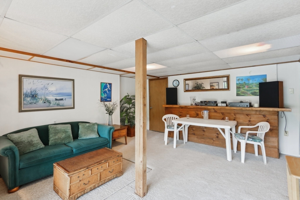 56 Pine Point Road Stow, MA 01775 - Photo 18 of 34 a living room with furniture kitchen view and a large window