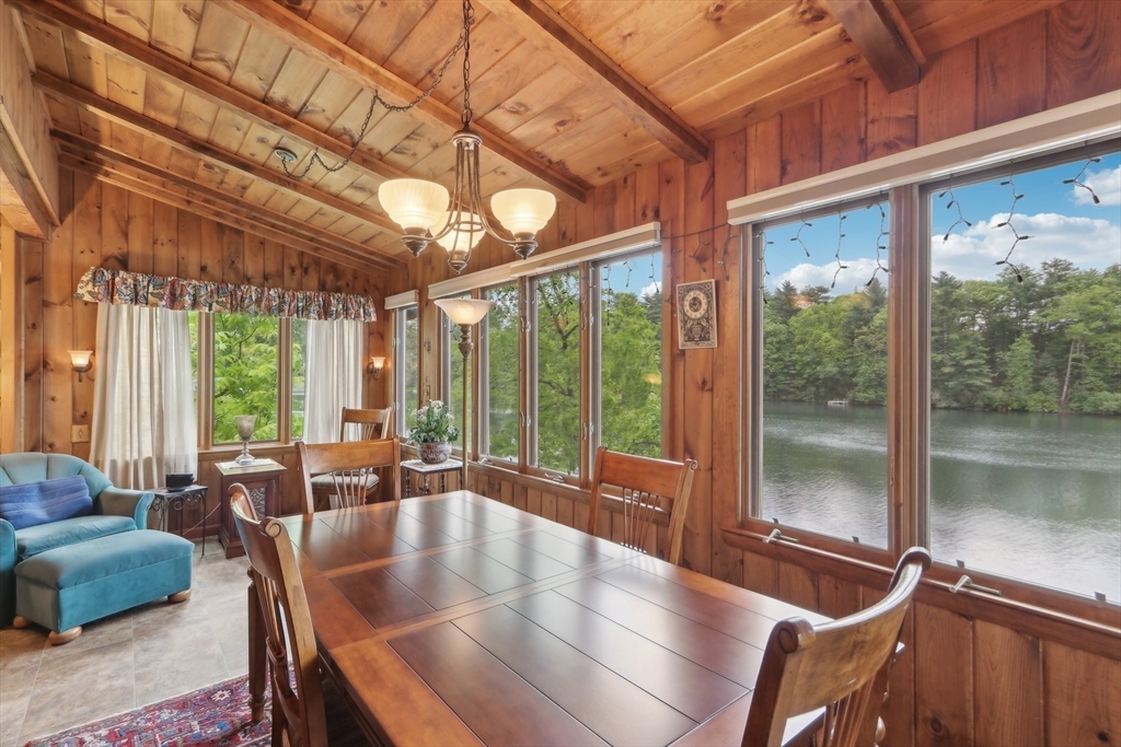 56 Pine Point Road Stow, MA 01775 - Photo 3 of 34 a dining room with furniture large windows and wooden floor