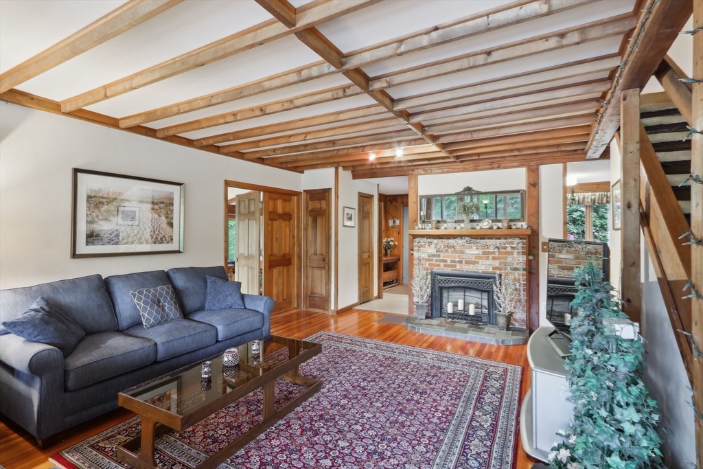 56 Pine Point Road Stow, MA 01775 - Photo 8 of 34 a living room with furniture and a fireplace