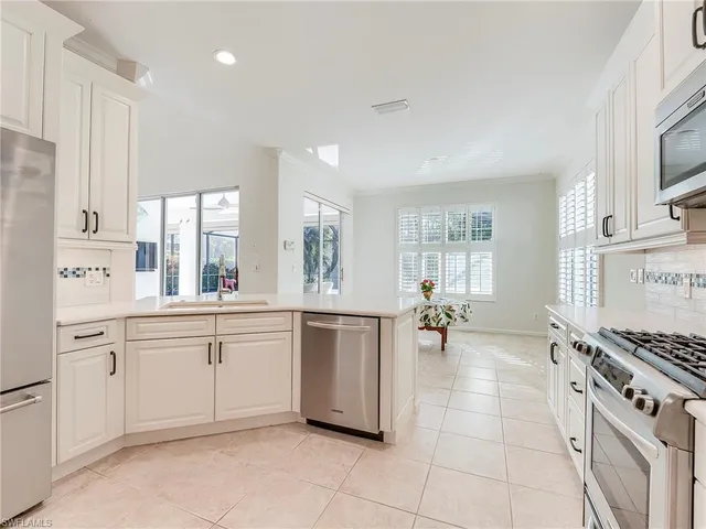 a kitchen with a sink and appliances