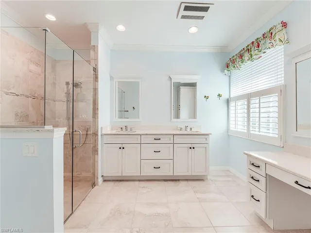 a spacious bathroom with a granite countertop sink a mirror a shower and a bathtub