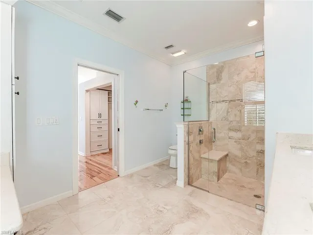 a bedroom with bed couch and window