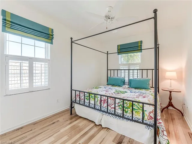 a bedroom with two bed and a window