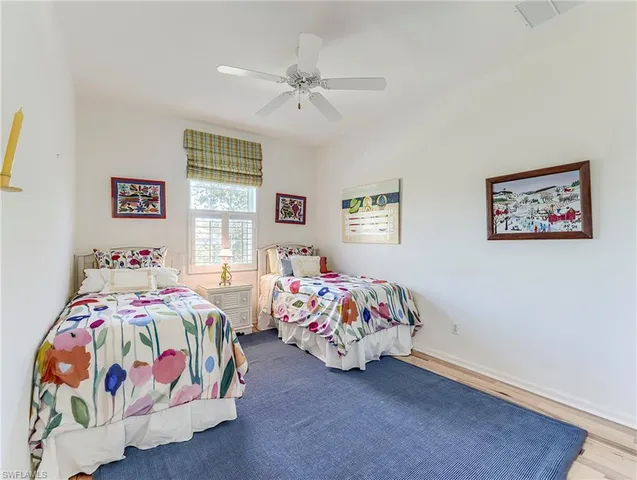 a bedroom with two beds and a window
