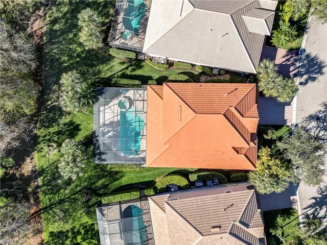 an aerial view of a house with a yard and wooden fence