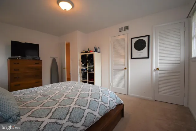 a bedroom with a bed and a television