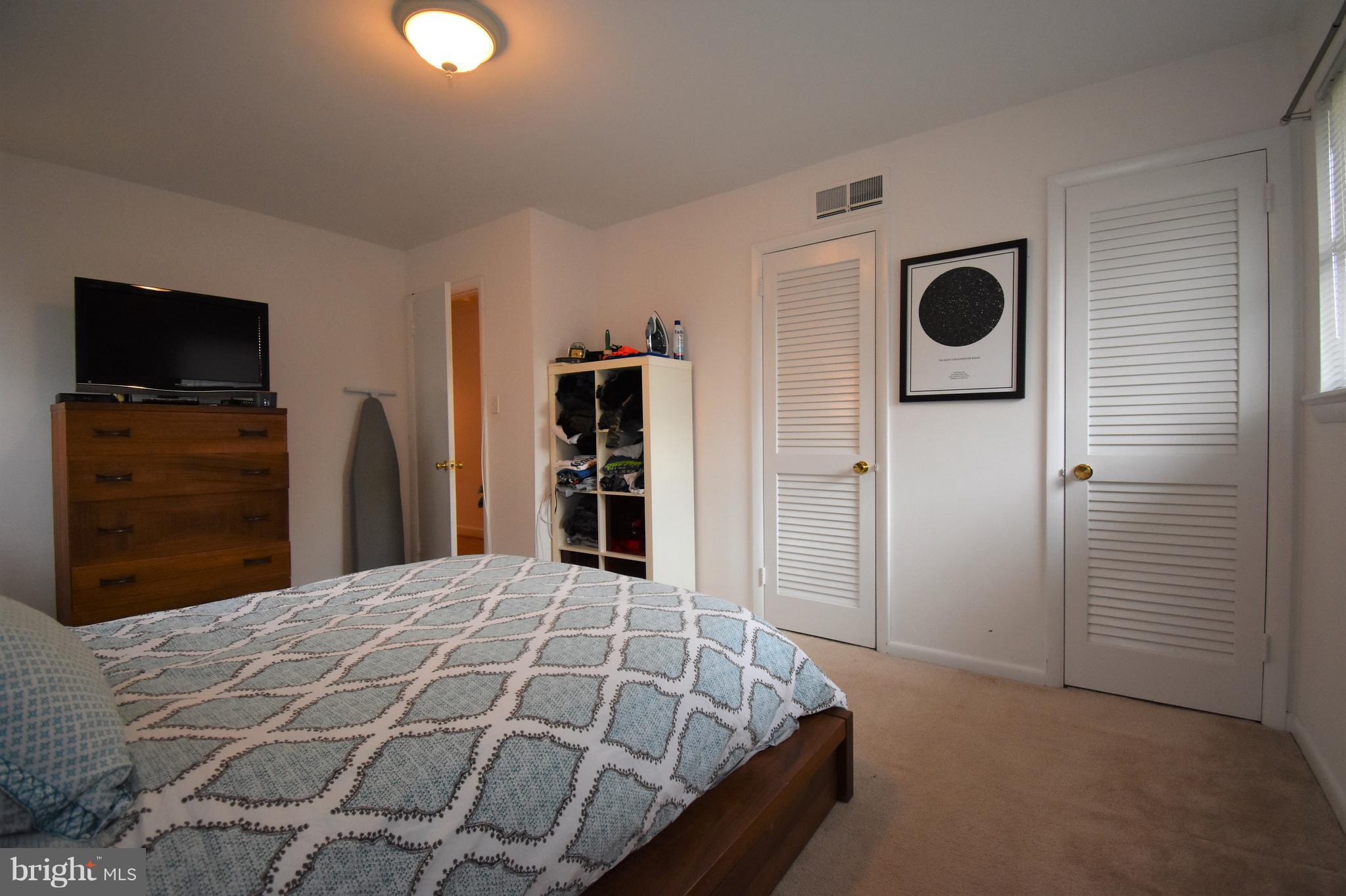 6405 Middleburg Lane Bethesda, MD 20817 - Photo 12 of 21 a bedroom with a bed and a television