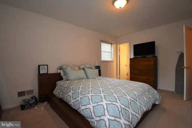 a bedroom with a bed and a television