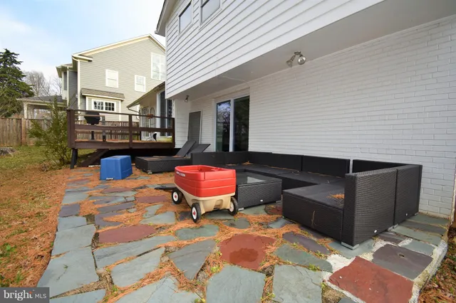 a backyard of a house with fire pit and outdoor seating