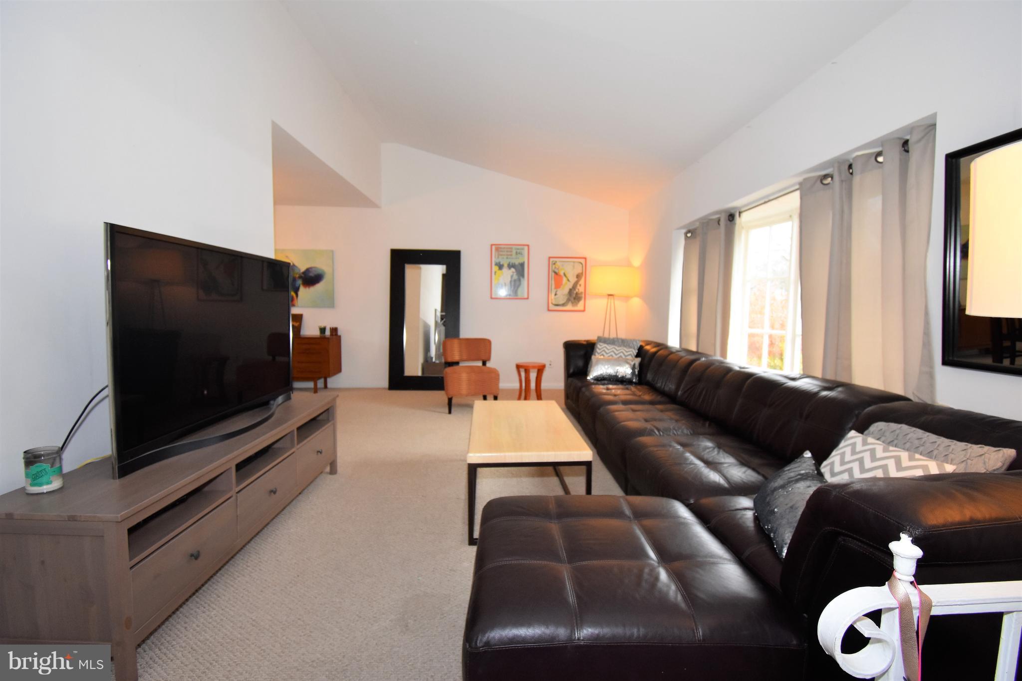 6405 Middleburg Lane Bethesda, MD 20817 - Photo 3 of 21 a living room with furniture and a flat screen tv