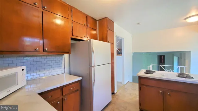 a kitchen with refrigerator and cabinets