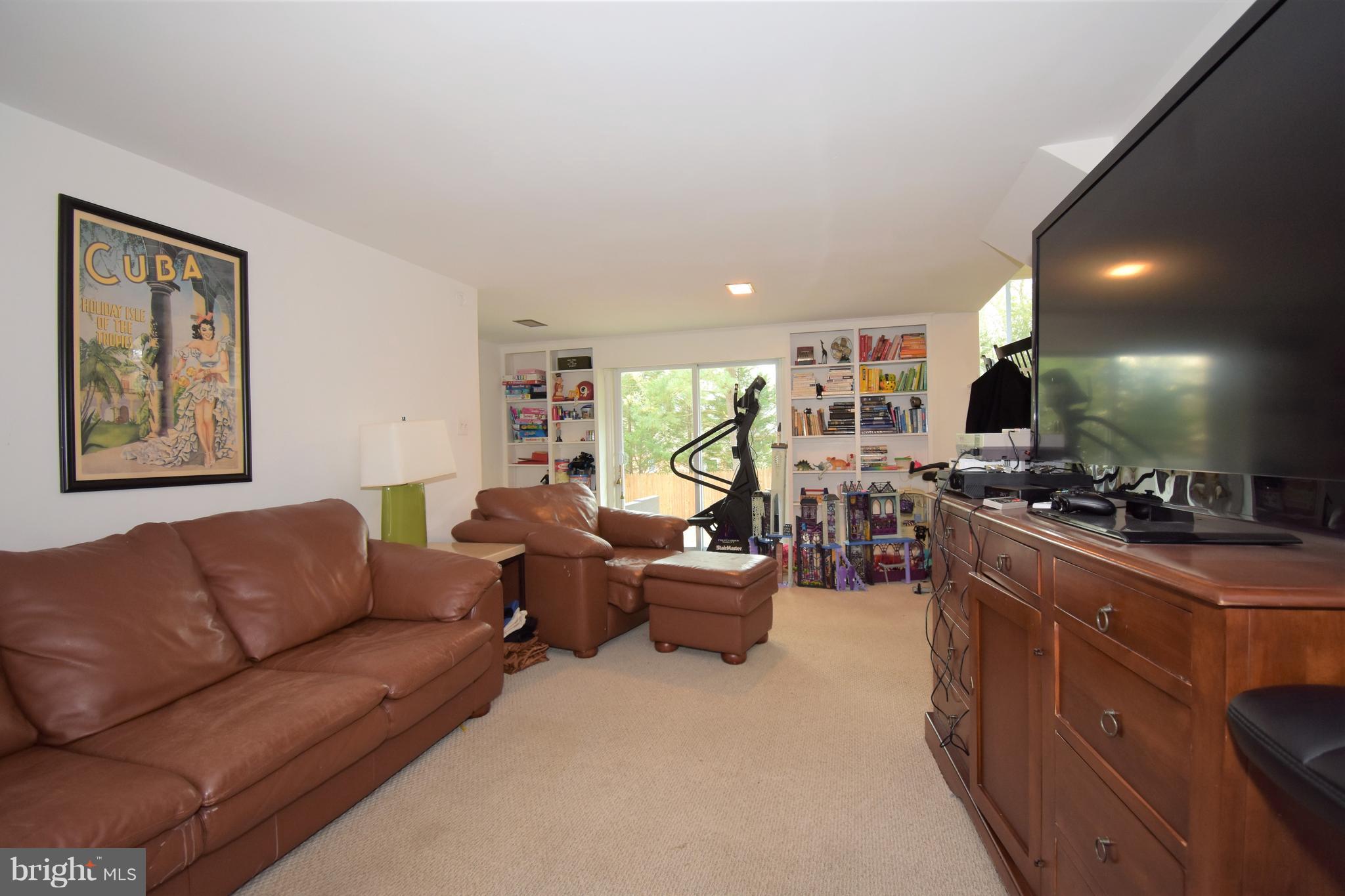 6405 Middleburg Lane Bethesda, MD 20817 - Photo 10 of 21 a living room with furniture and a flat screen tv