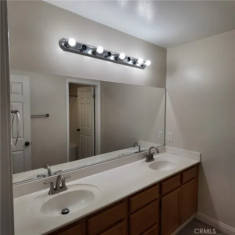 a bathroom with a sink double vanity and a mirror