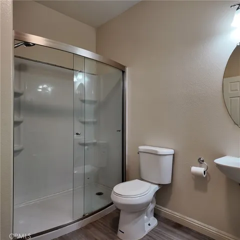 a bathroom with a toilet and a shower