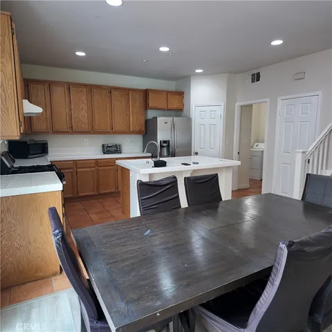 a large kitchen with a table and chairs