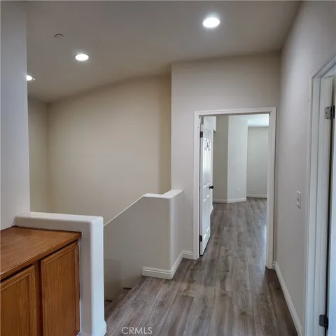 a view of a hallway with wooden floor