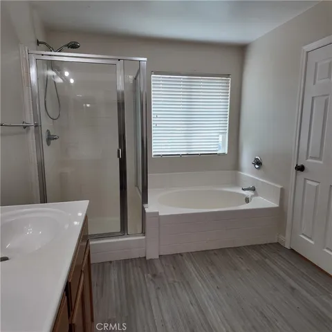 a bathroom with a bathtub and a shower