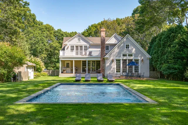 a front view of a house with a yard table and chairs