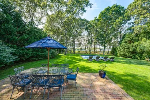 a view of a table and chairs under an umbrella