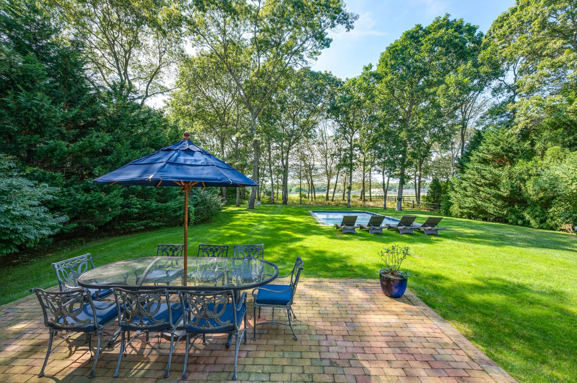 Undisclosed Address Water Mill, NY 11976 - Photo 17 of 28 a view of backyard with swimming pool and outdoor seating